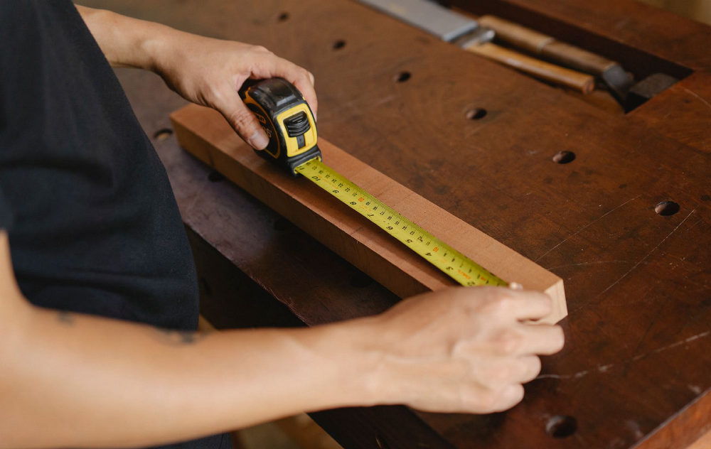 A carpenter marking a measurement on timber